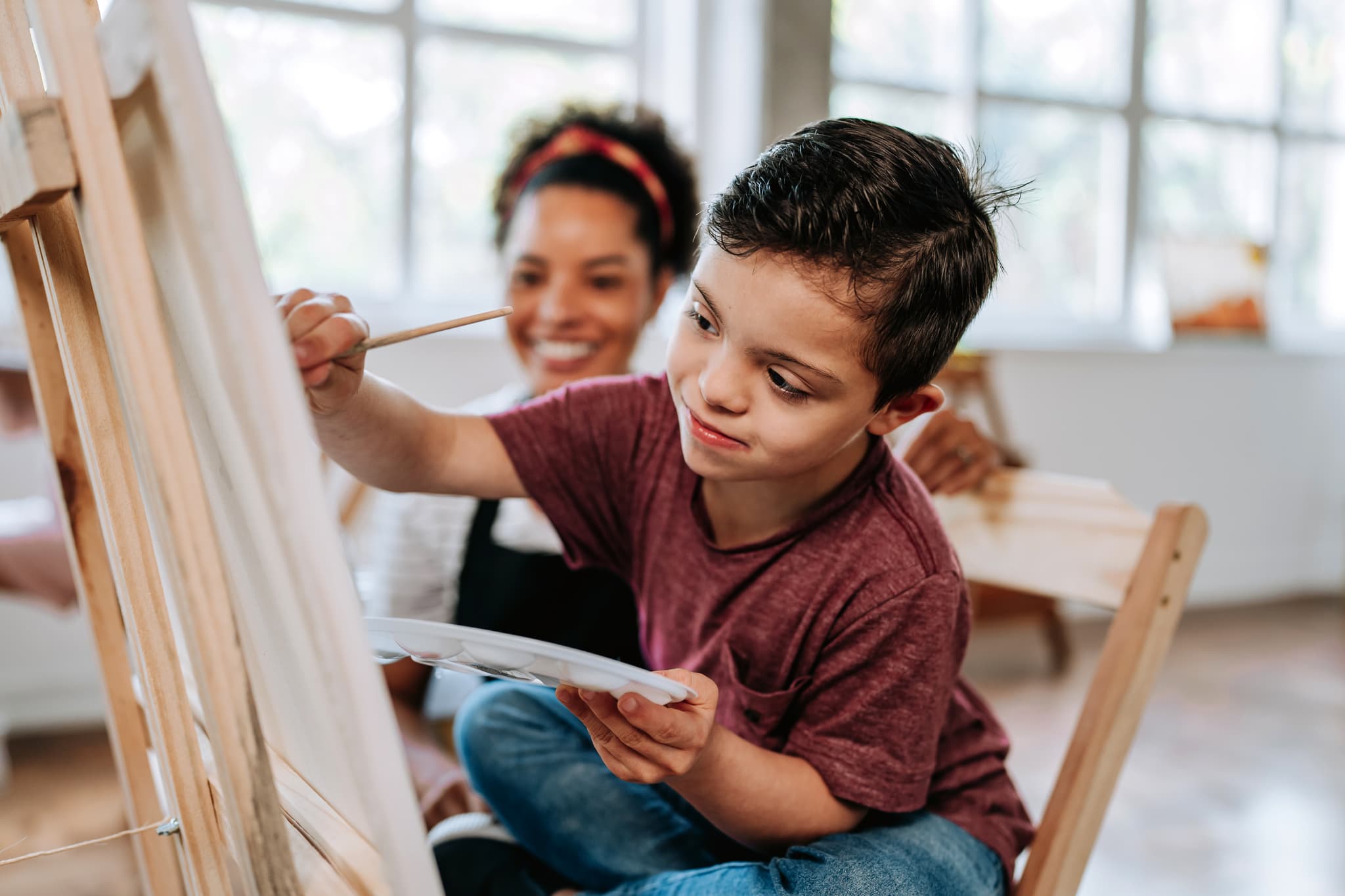 Child working on creative skills with a therapist