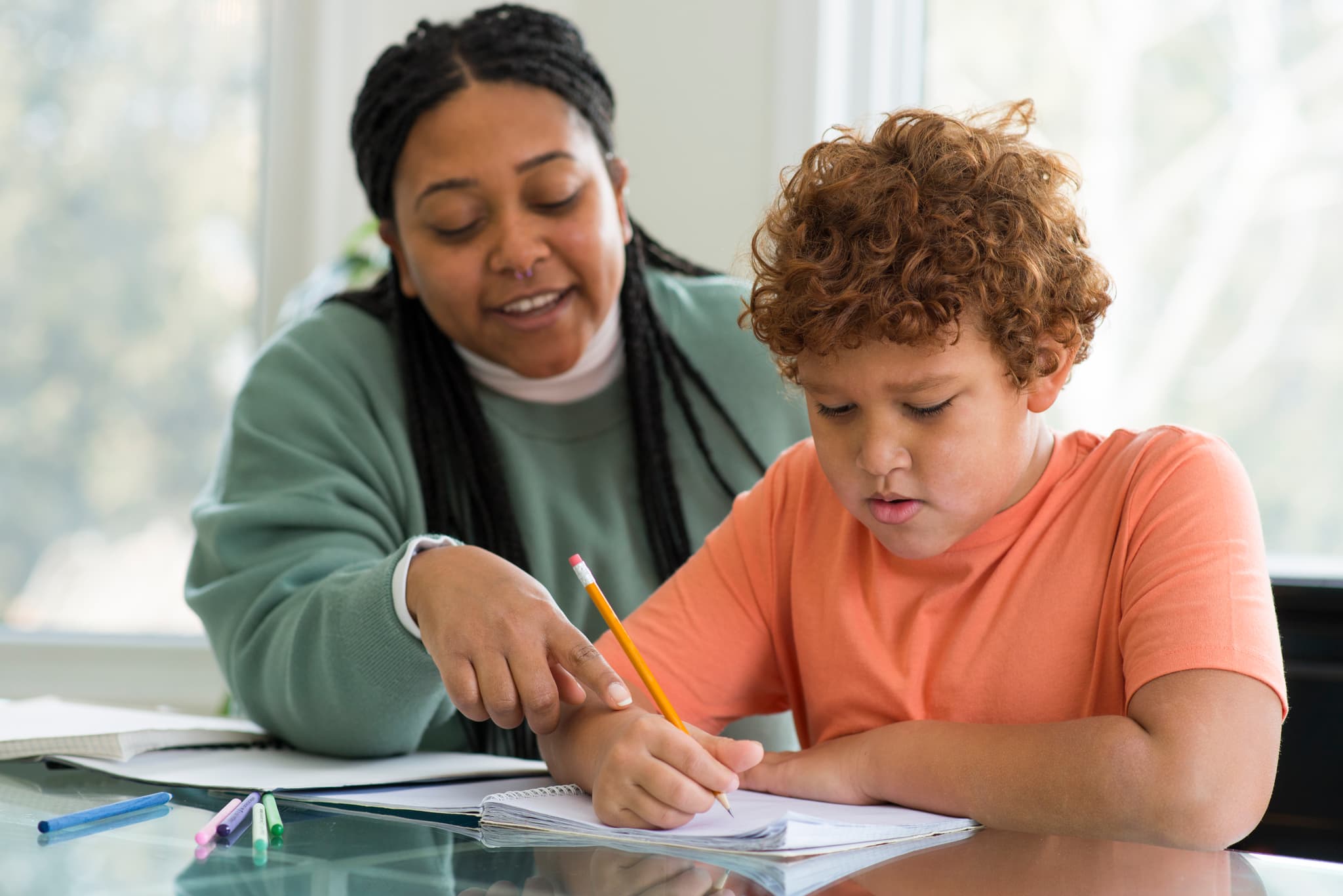 Teacher helping student with classwork